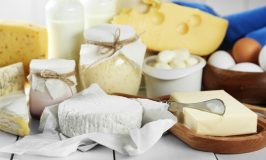 Set of fresh dairy products on white wooden table
